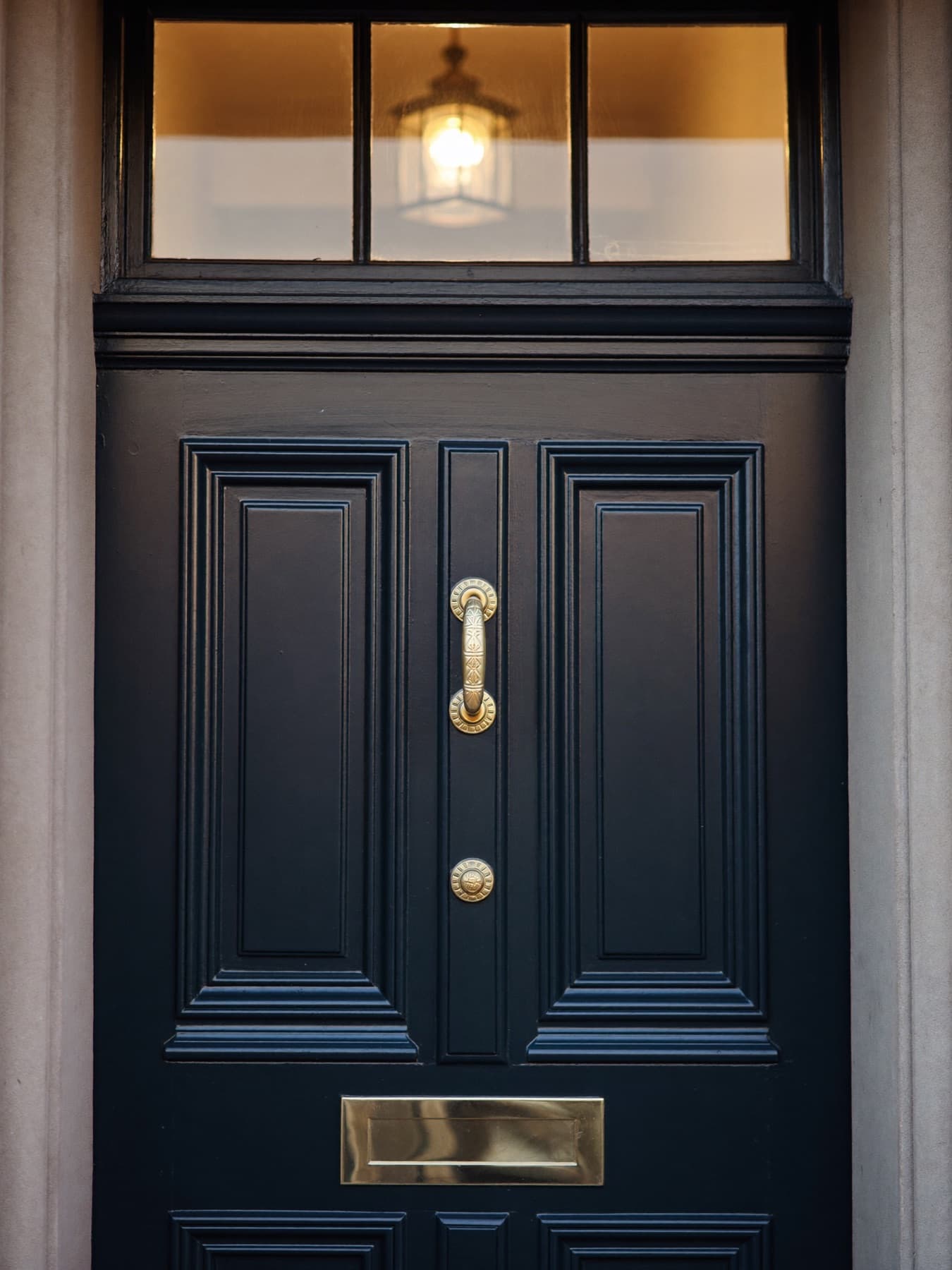 A discreet London townhouse door at dusk